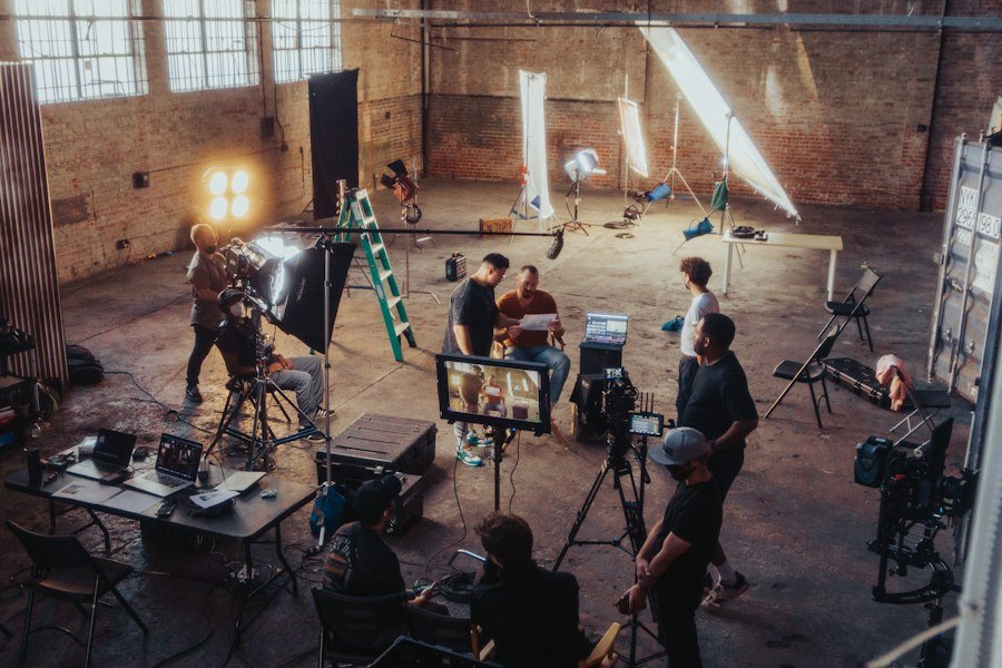 A small crew setting up a camera for a shoot